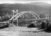 Ett par kilometer SO om Norra Finnskoga kyrka vid B�tstad passerar allm�nna v�gen �ver �lven via den nya betongbron. I f�rgrunden den gamla B�tstadsbron, som revs 1955-56, d� den nya f�rdigst�lldes.
