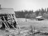 I f�rgrunden ser vi den raserade sommarladug�rden vid Strandmon och i bakgrunden till h�ger den ombyggda ladug�rden.